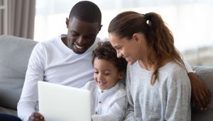 A family looking at a laptop together